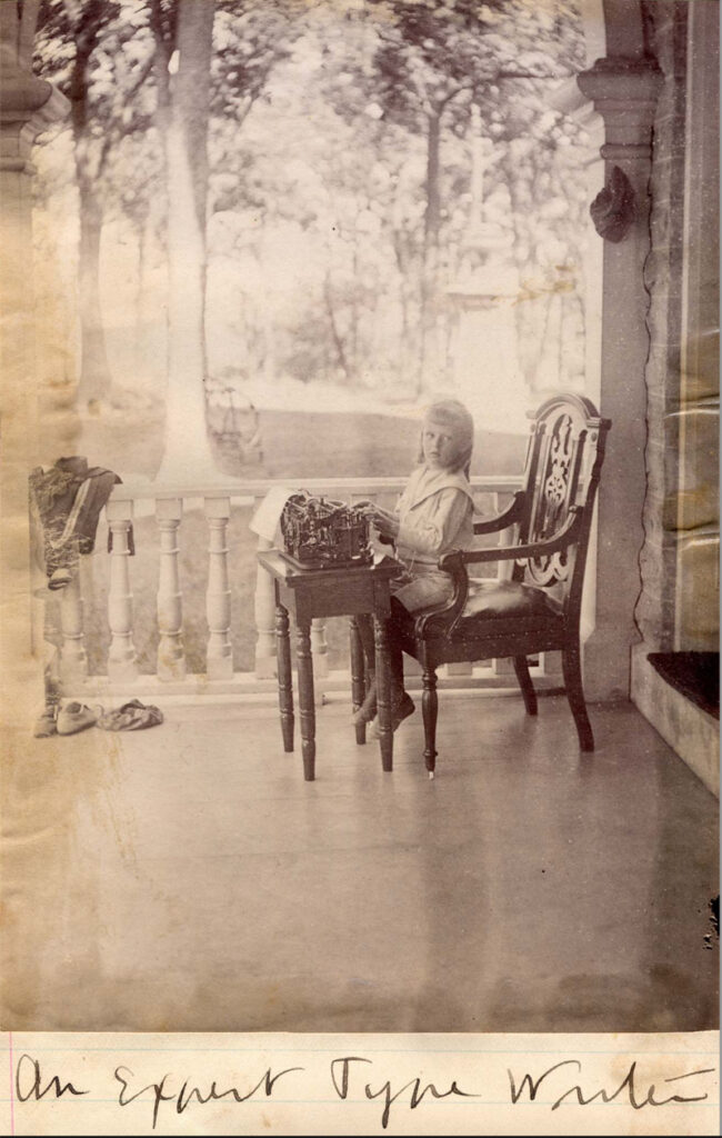 Circa 1895 studio photo showing a young girl seated with a National typewriter.